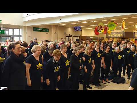 Norwich Rock choir singing at Morrison Norwich