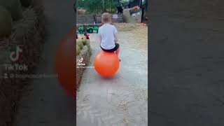 Boy Bouncing on Orange Hopper Ball