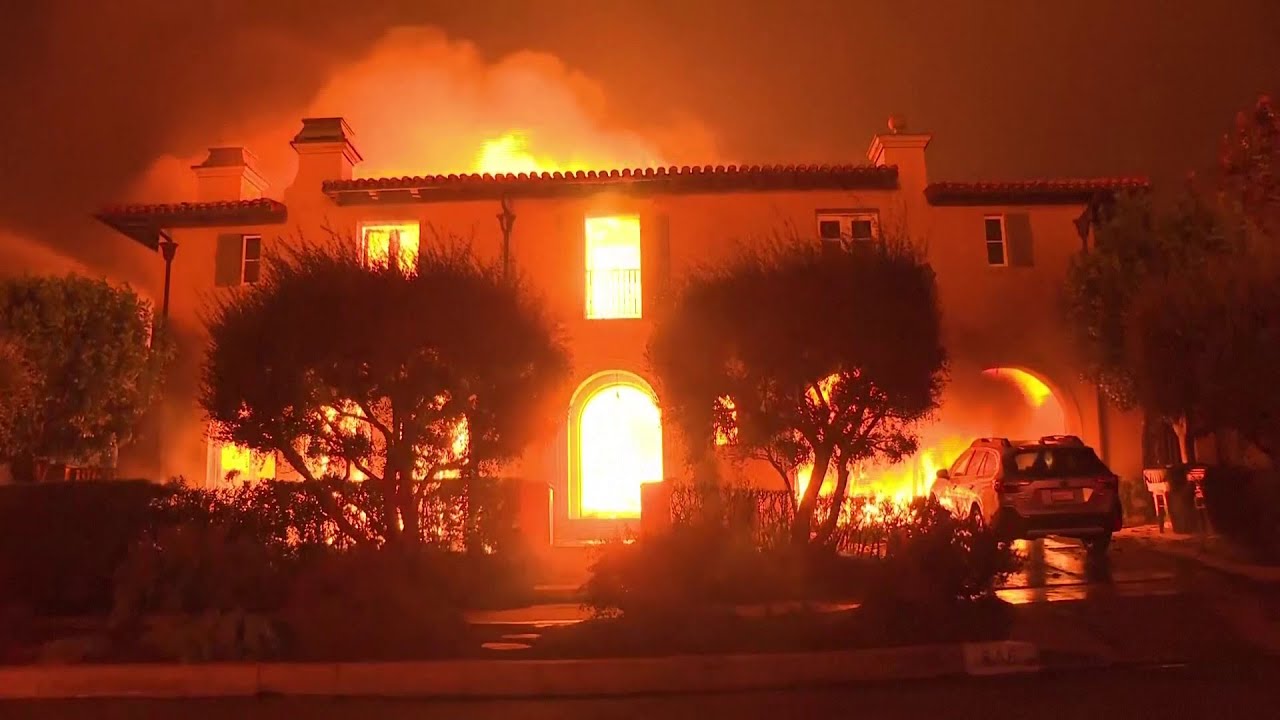Thousands flee, homes are destroyed as wildfires burn out of control in and around Los Angeles