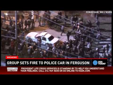 Ferguson protesters flip, set fire to police car