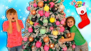 Alika and Max Decorating the Christmas Tree by Globiki