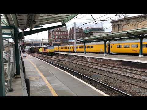 Colas rail 60021 hauling a consist of logs through Carlisle