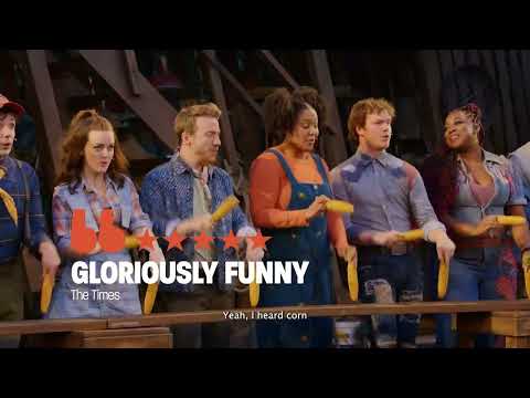 Shucked trailer still with cornfield backdrop and jubilant cast button pose