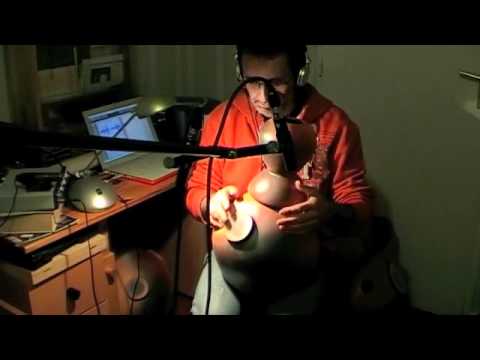 Demonstration with udu drum 28 two volume over a bell and a drum