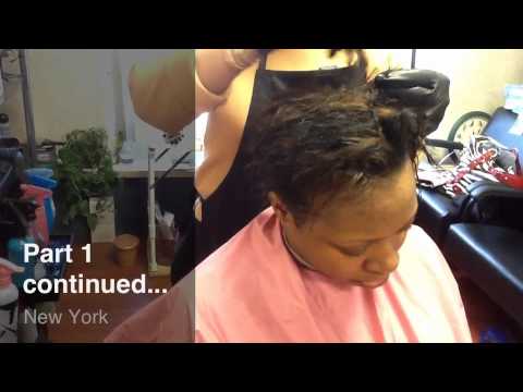Hair stylist applying scalp treatment to a client with short hair, showcasing salon techniques for clean scalp preparation and styling, in a salon setting with styling tools visible.