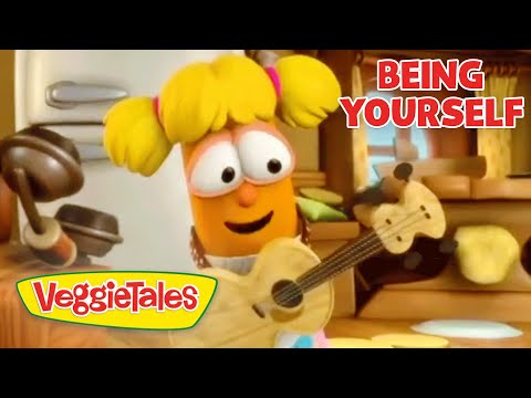 Orange VeggieTales character with yellow pigtails plays a guitar in a cozy kitchen scene; VeggieTales logo visible and 'Being Yourself' text top right.