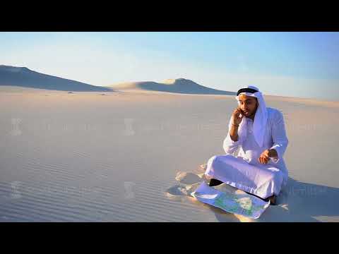 Successful Arabian Sheikh businessman communicates on smartphone with business partner sitting on