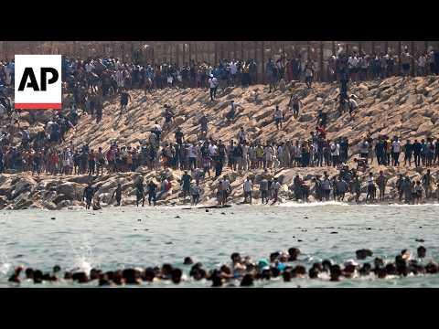 Video Thumbnail: Thousands of migrants swim around the border from Morocco into Ceuta, Spain