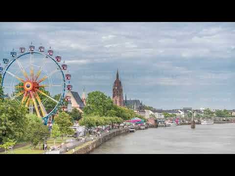 Aerial hyperlapse of pleasure boats on the Rhine Main, framed by the spire of Kaiserdom St