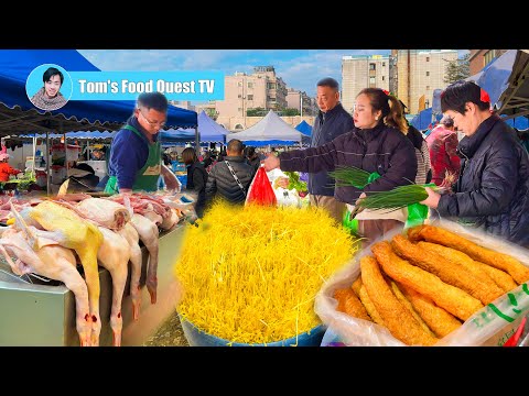 Traditional market in southern China: morning market scene with lots of vegetables and fresh meat