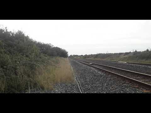 67015+8229 pass a crossing in preystatyn with a nice 3 tone working:holyhead-Cardiff central