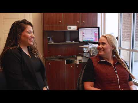 Dental patient Crystal smiling at dental team member