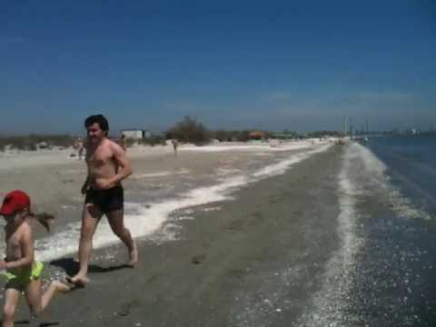 Father and girl running on the beach