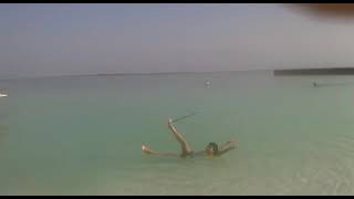 Amazing girl float in the dead sea with hula hoop. / ah!