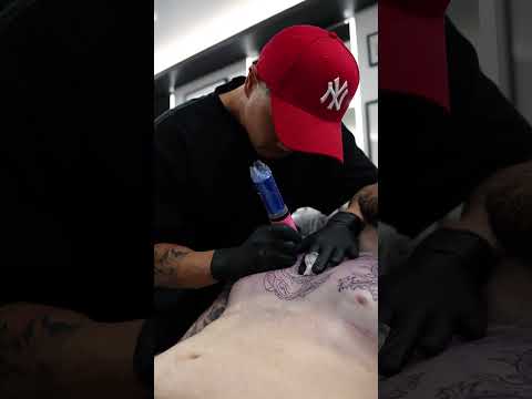 Completing the line work on this oriental chest tattoo