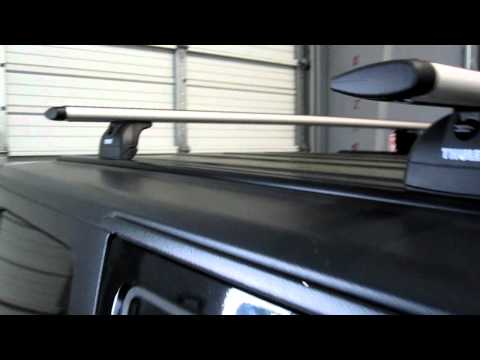 Jeep Wrangler Unlimited with Thule Rapid Podium Aeroblade Roof Rack on Tracks by Rack Outfitters
