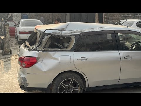 Damaged Nissan Wingroad with Front-End Collision in AutoMaster Workshop
