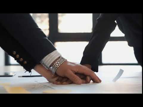 close up of happy multiethnic adult business people holding hands together team spirit in a modern m