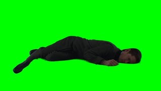 Syril Karn lying in bed — Andor green screen