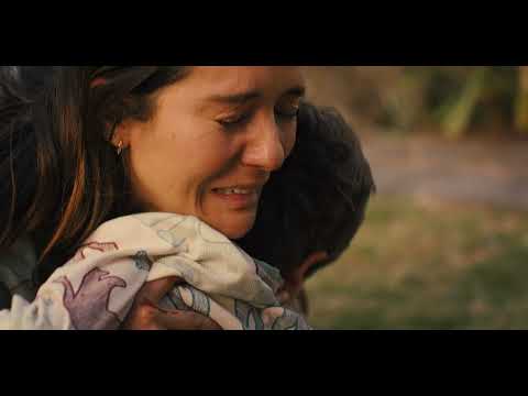 Trailer beat: Christmas lights flicker over a grieving father as a harsh percussive motif grinds