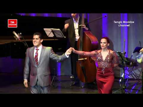  Ruben Veliz  and  Sabrina Veliz  are  dancing  to  the  tango  "  Nochero Soy  "  by  Solo Tango Orquesta  at  Planetango Moscow  in  2014