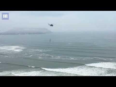 Peruvian Air Force recruits dangle perilously from a helicopter
