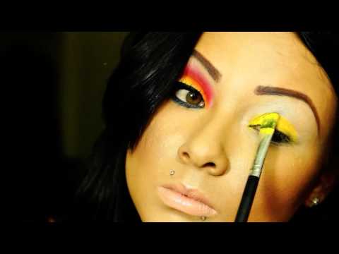 yellow and orange with a pop of blue make up look
