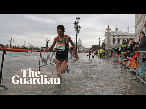 Marathon runners race through Venice's flooded streets