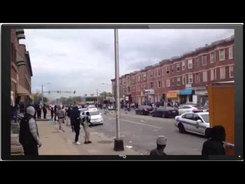 Baltimore - Rioters Throwing Rocks at Passing Police Cars