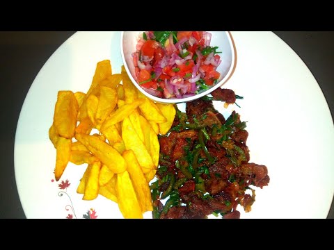 Fried Pork. Served with chips (fried potatoes) and Kachumbari (salad)