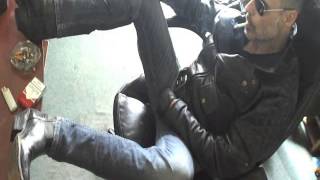 Smoking in leather jacket and cowboy boots