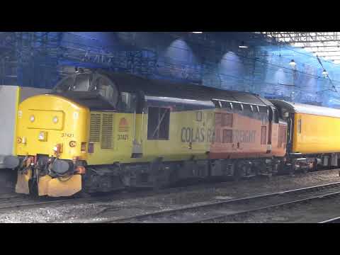 Colas 37421 moves north out of Carlisle station
