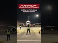 Airport ground crew directs Boeing 737 to park, looking as if he’s doing rhythmic exercise