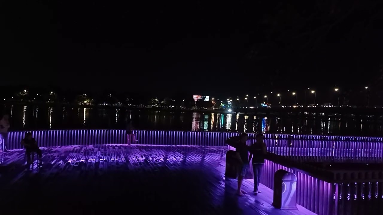 Discover Lim Wooden Bridge illuminated at night.
