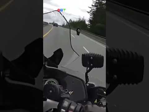 Motorcyclist does wheelie in front of police