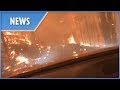 Father and son drive into a wildfire
