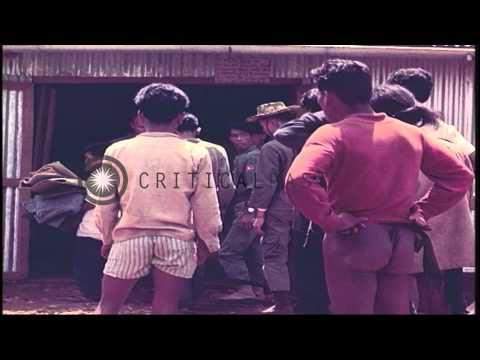 Montagnards receive clothes and shoes from Sargent Juniewicz of US Special Forces...HD Stock Footage