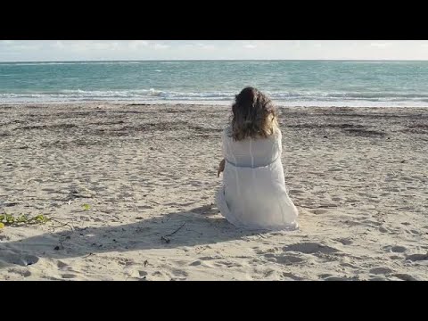 Woman Sitting On The Beach Stock Video