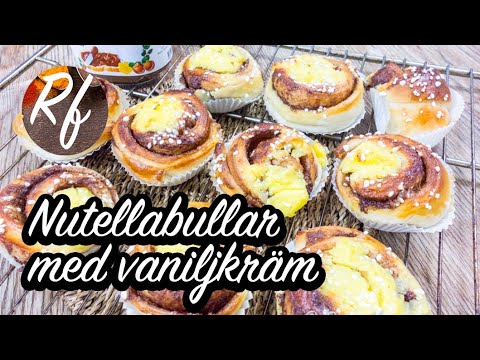 Nutellabullar eller Nutellasnäckor toppade med vaniljkräm. Nutella eller hasselnötscreme som fyllning och vaniljkräm som topping. Dubbelt så gott. Här med hemgjord vaniljkräm som blir mycket gott. Man kan också ta vaniljkräm från pulver.>