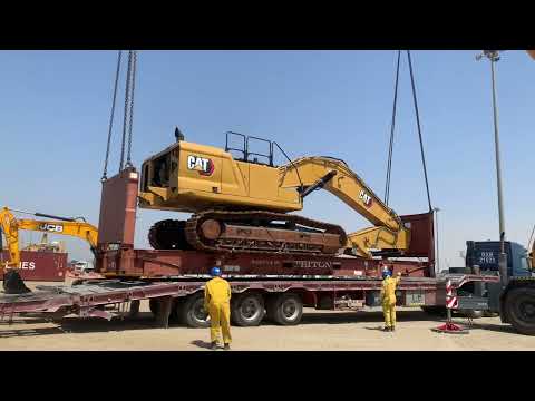 Using two Crane to off load this caterpillar 350 Excavator from the trailer. heavy equipment