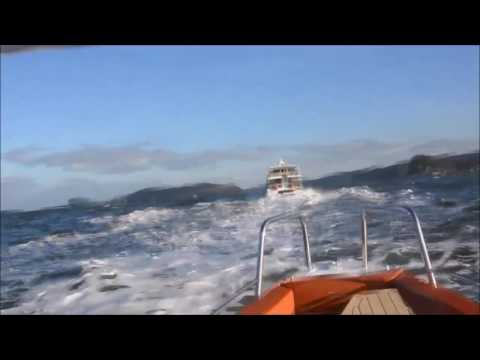 Axopar 28 T Top cruising through rough water