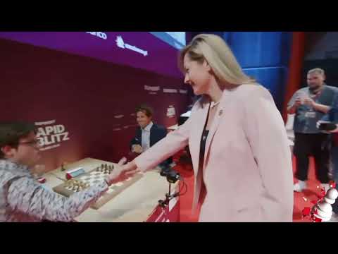 Magnus Carlsen smiles after GM Natalia Zhukova's ceremonial A4 move