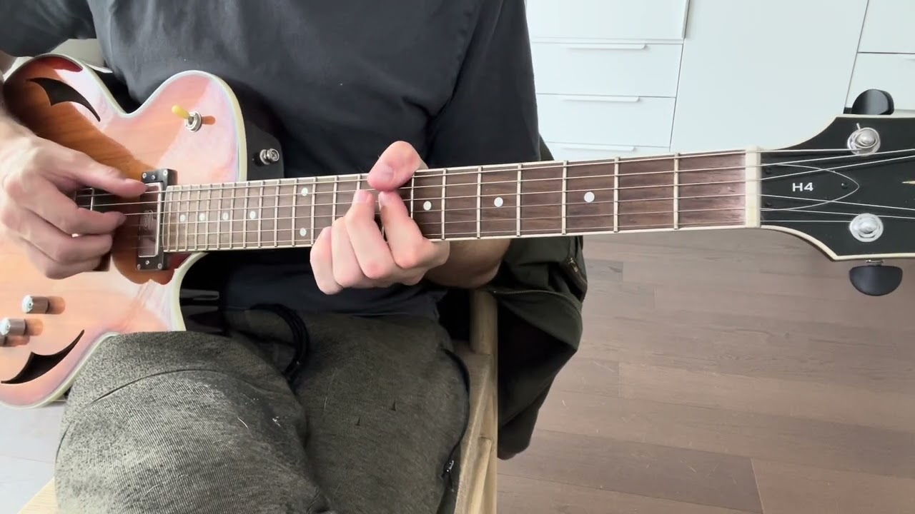 Guitarist demonstrating jazz blues comping chords rooted on the low E string