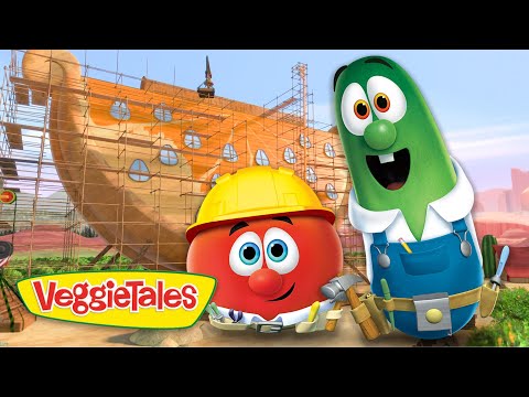 Tomato and cucumber VeggieTales characters in hard hats stand beside a ship under construction with scaffolding, logo visible on the bottom left.