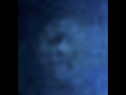 Caught on camera: Blue Orb zoomed in with several faces seen inside!