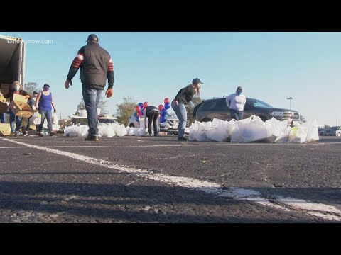 Volunteers help in frozen turkey drive-through giveaway in Norfolk