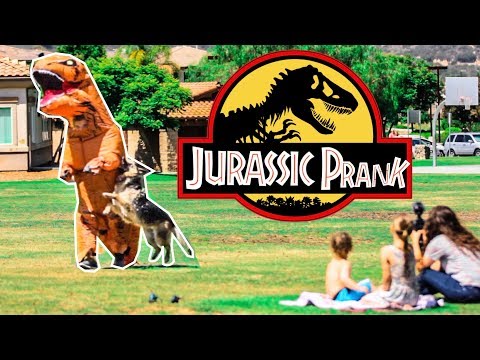 Thumbnail showing a giant dinosaur cutout overlapping a man in a park, with kids filming nearby and a large 'Jurassic Prank' logo in the center.