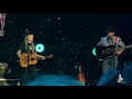 George Strait and Willie Nelson perform together for the first time.