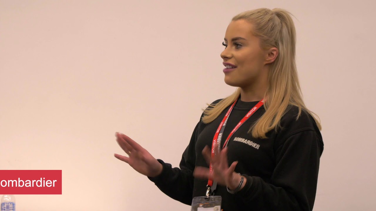 A blonde lady, speaking in a navy blue Bombardier jumper.