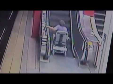 woman in wheelchair on escalator is a slinky